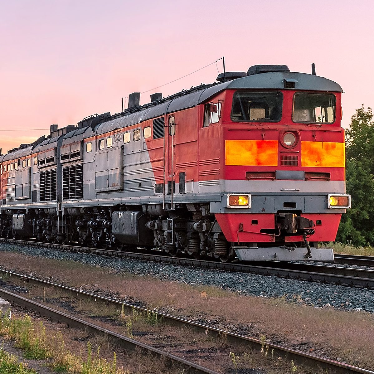 Ein Zug fährt an einem Bahnsteig vorbei.