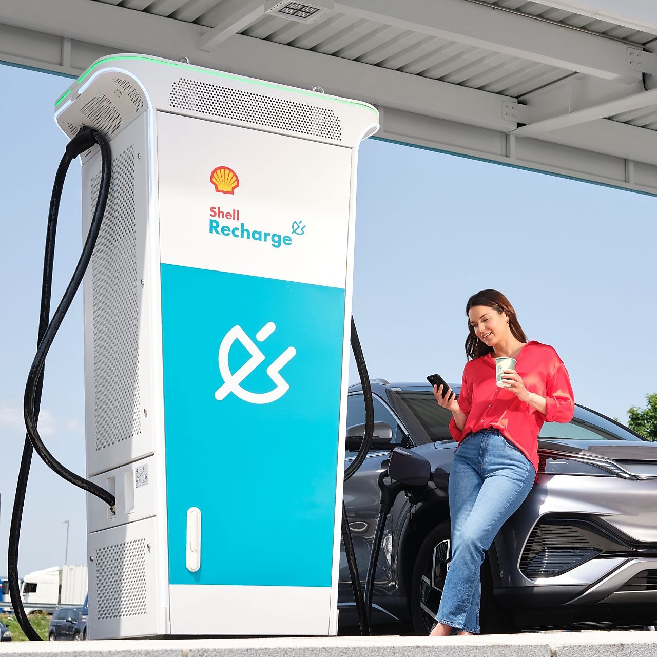 Woman using charge card at a Shell Recharge Station